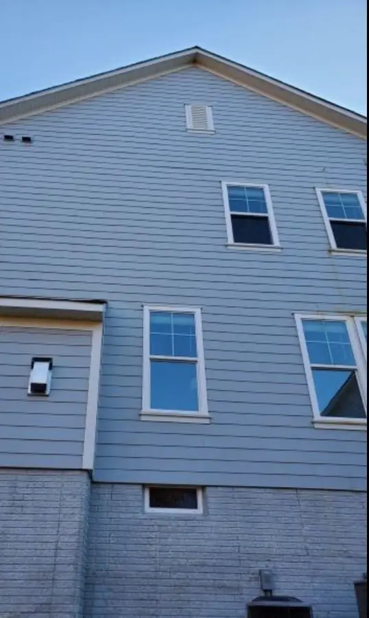 The same siding after a house wash, an even blue-grey